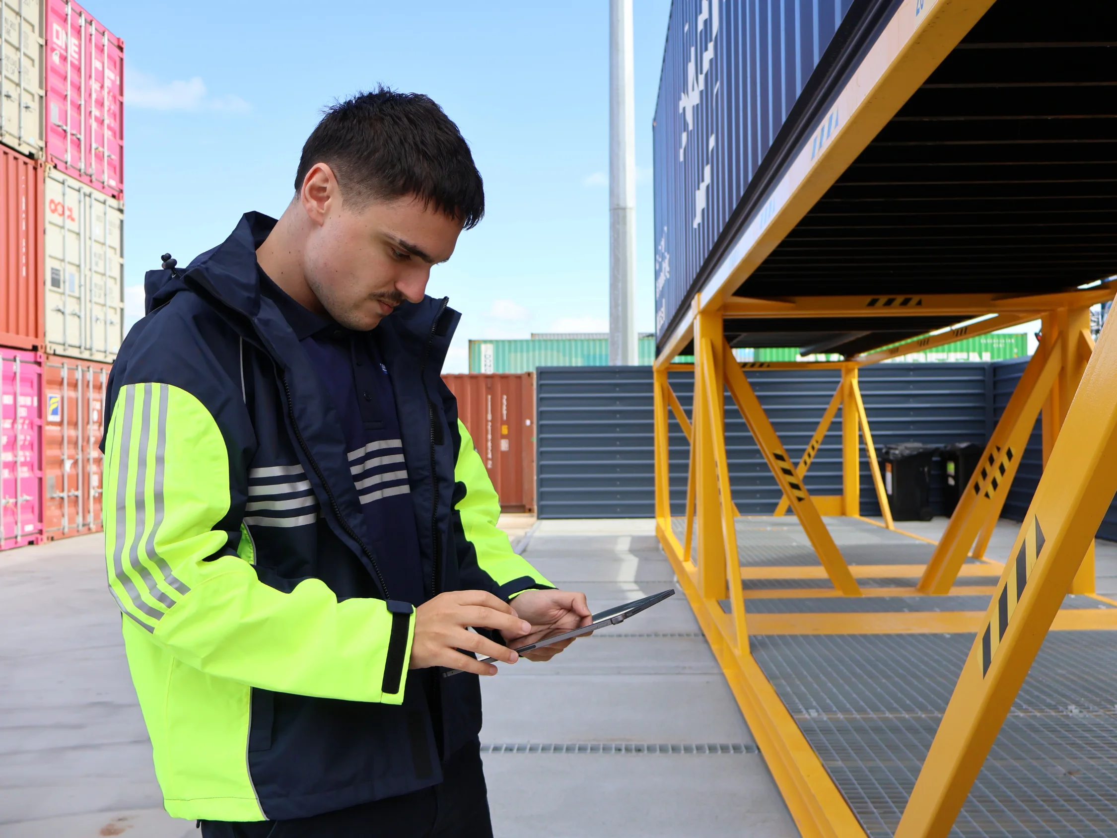 Mainfreight team member carrying out inspections of a container on the rural hard stand