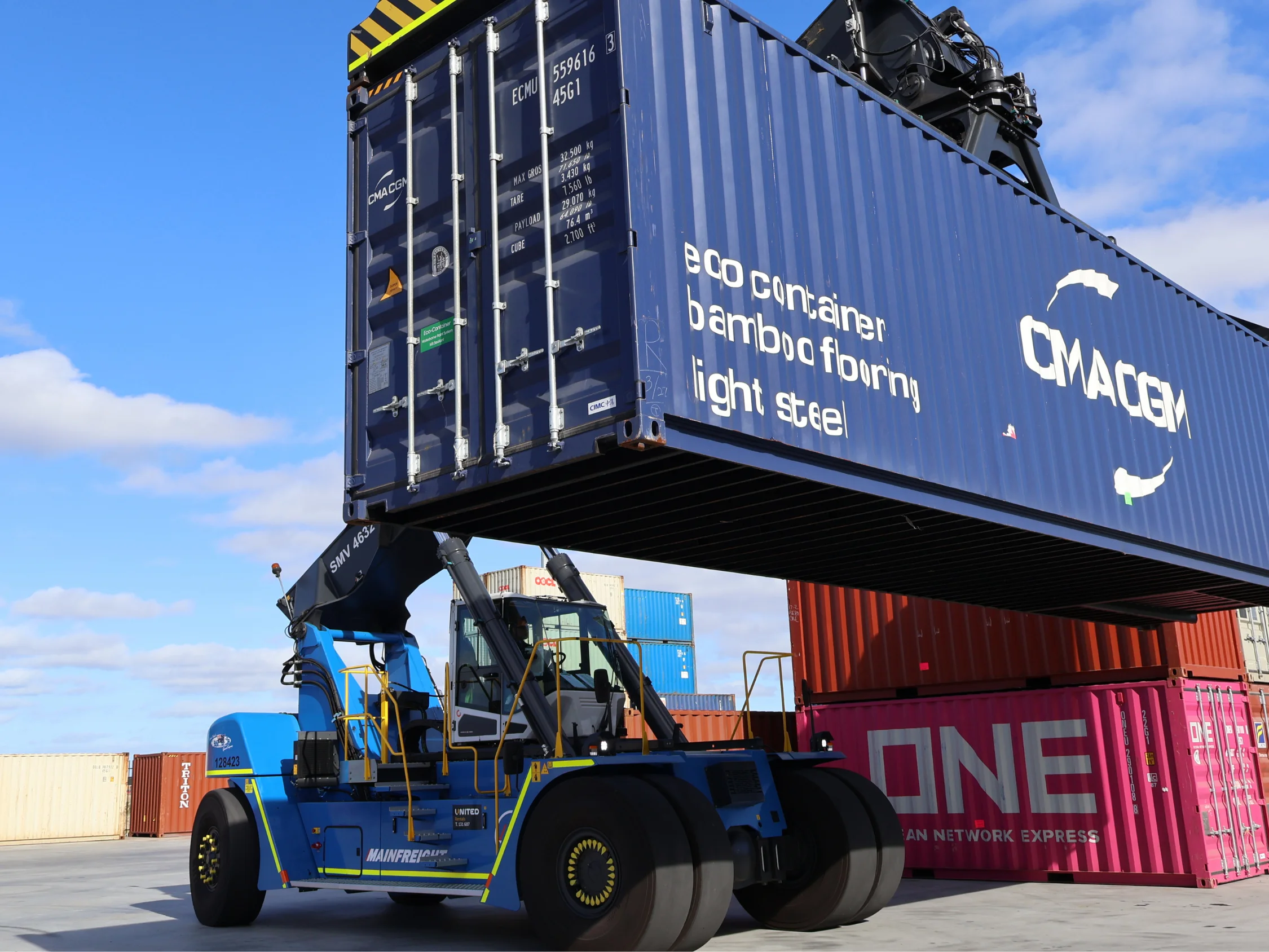 Stacker moving a blue container 