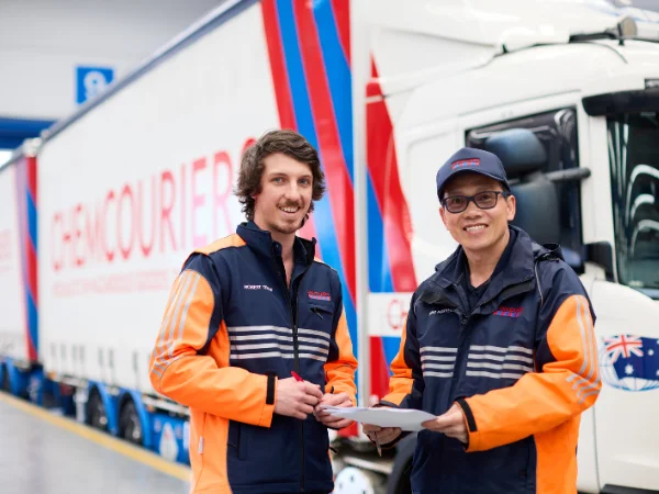 Chemcouriers Chain of Responsibility  - Two Chemcouriers Team Members in front of a truck