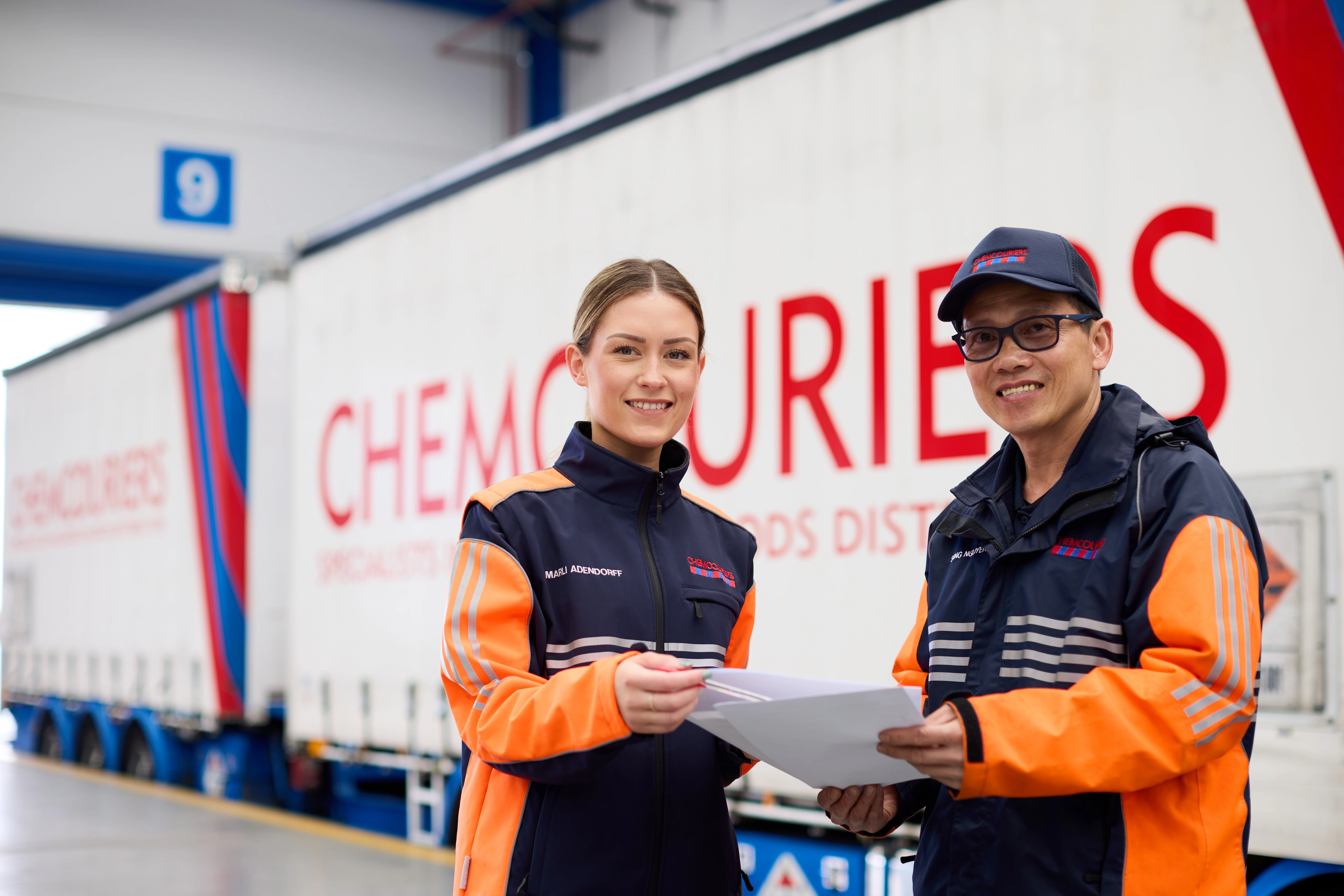 How many Dangerous Goods are there? - Two Chemcouriers team members wearing protective gear at a Dangerous Goods Depot